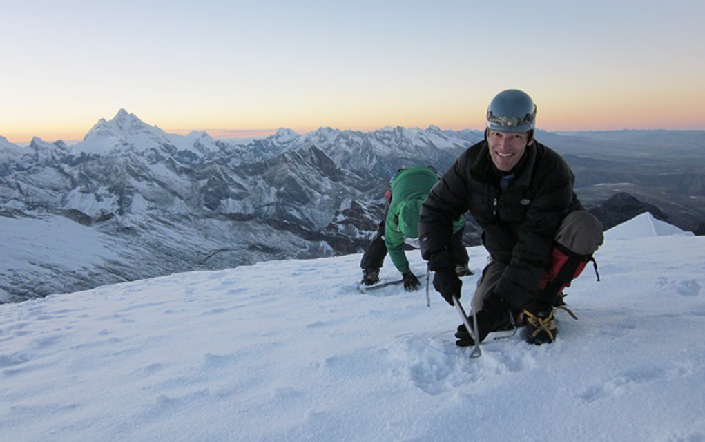 Carl Schmitt (front) and mountain guide Cesar Alvarado collect snow samples at the summit of Vallunaraju mountain in the Cordillera Blanca.