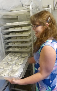 Andrea Davis checks trays of her Dark Moon goat cheese rounds at Broken Shovels Farm. 