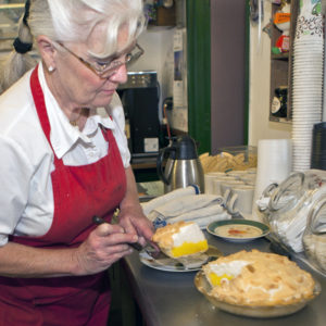 Virginia Smoot cuts a slice of her traditional lemon meringue pie at the Corner Café in Colorado Springs.