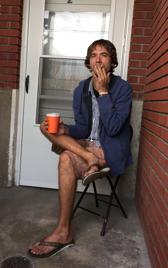 Bradley Books smoking outside his Longmont apartment.