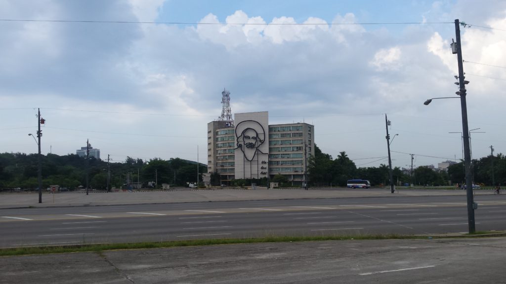 A steel memorial of Camilo Cienfuegos looks out of Plaza de la Revolucion in Havana, with the quotation "Vas bien, Fidel" (You're doing fine, Fidel).