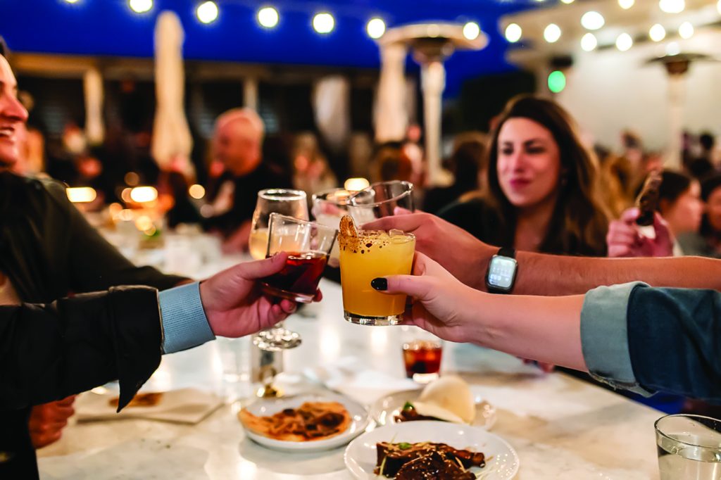 Diners toast on Rosetta Hall's rooftop during First Bite