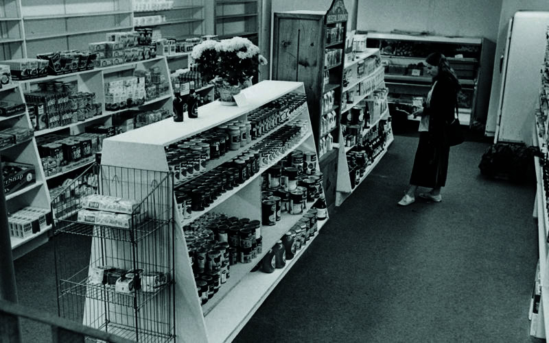 A woman stands near a Celestial Seasonings display at New Age Foods, a health food store located at 1122 Pearl St. natural foods