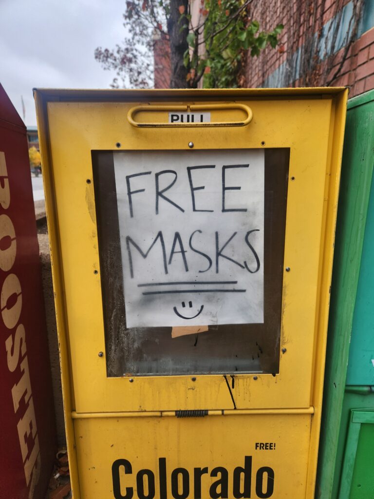 Free COVID masks sign in a newspaper stand distributed. 