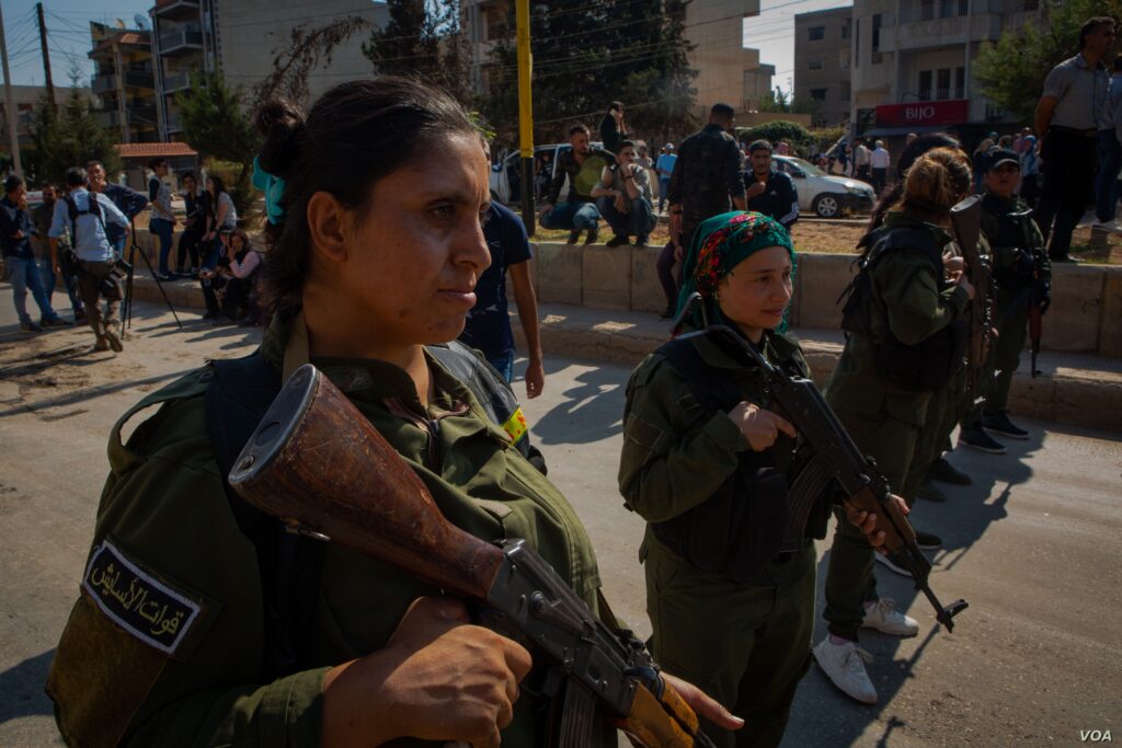 Kurdish military forces gather in Syria where refugee Rohan Mesto lived